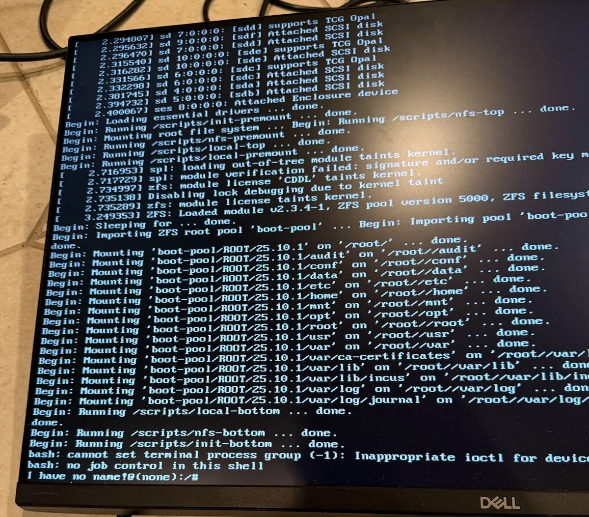 The recovery shell on the NAS console: the full boot sequence mounting the ZFS boot pool, ending in a bash prompt reading I have no name!@(none)